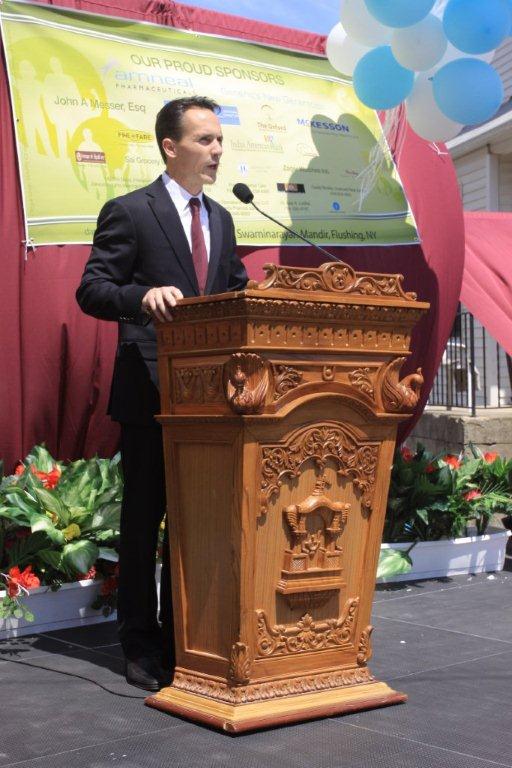 a man standing at a podium with a microphone