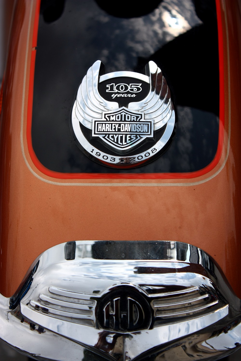 a brown and orange vehicle has an emblem and number on the side