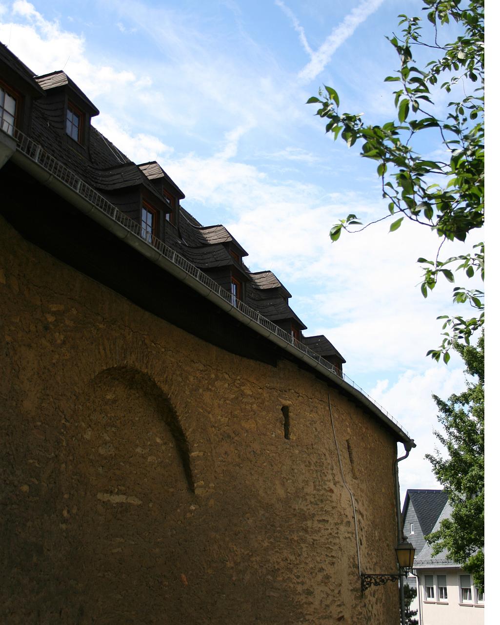 a city wall has a small carved face in it