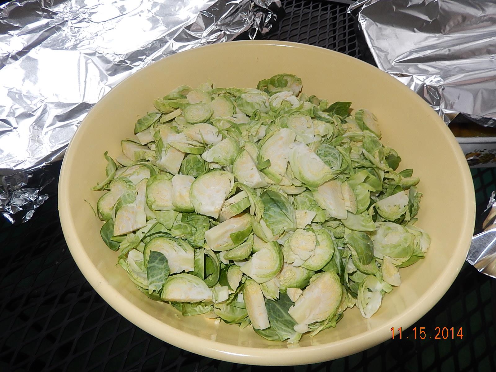 a bowl of green vegetables covered in aluminum foil