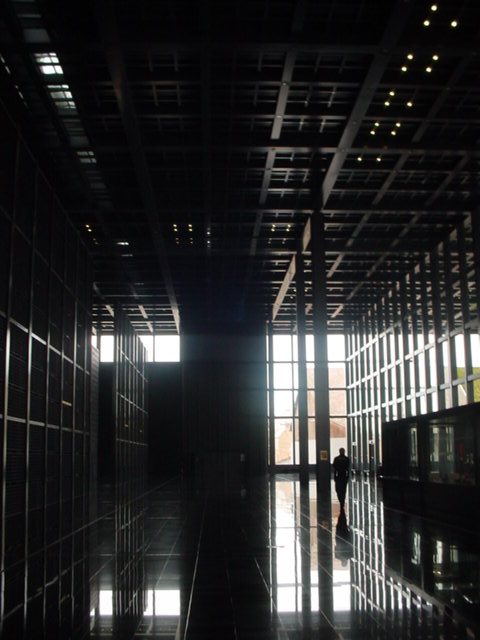 a person standing inside of a large glass room