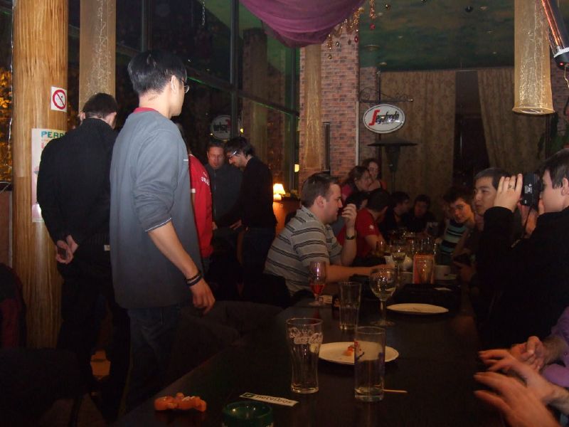 a group of men drinking at some tables