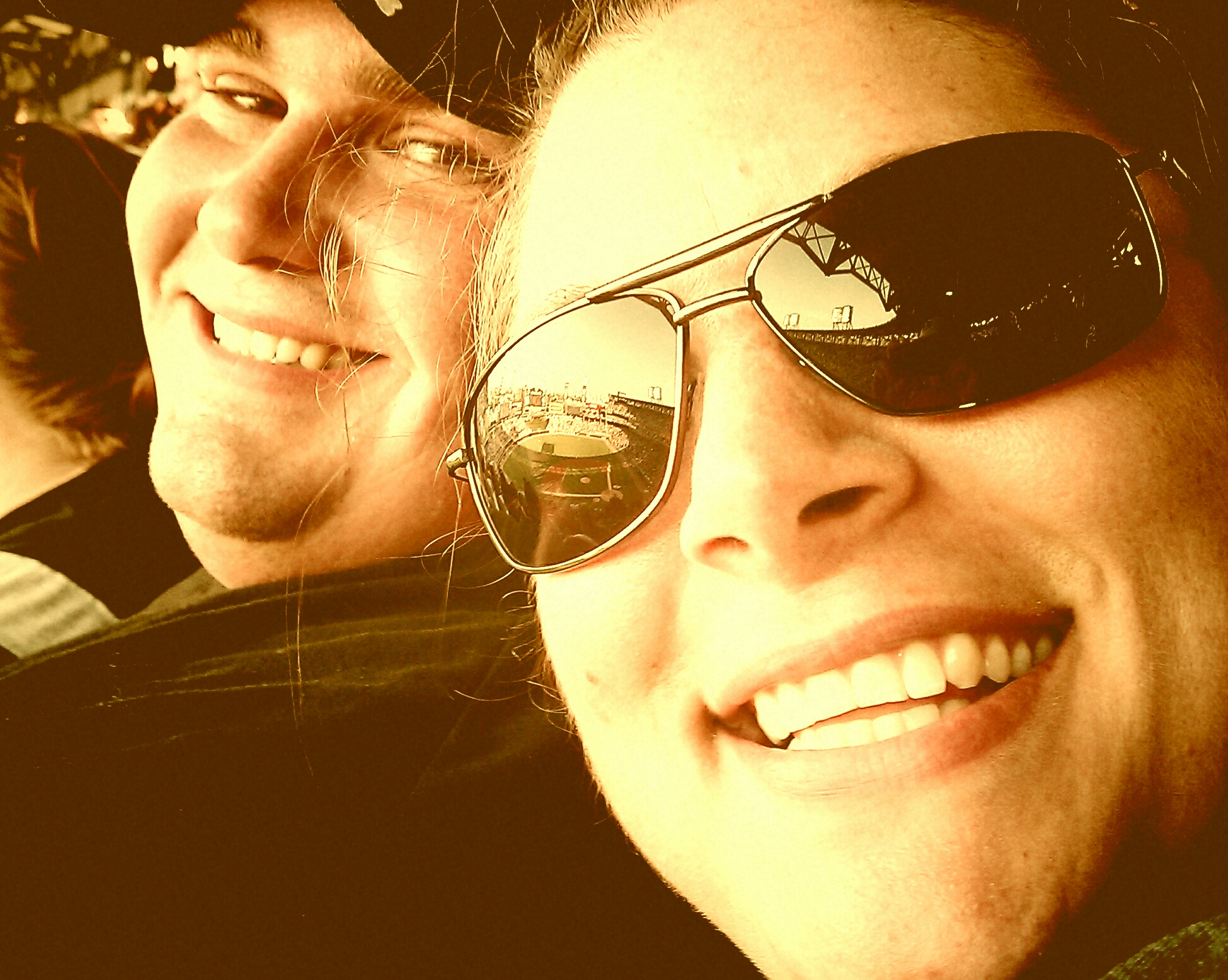 two people with sunglasses posing for the camera