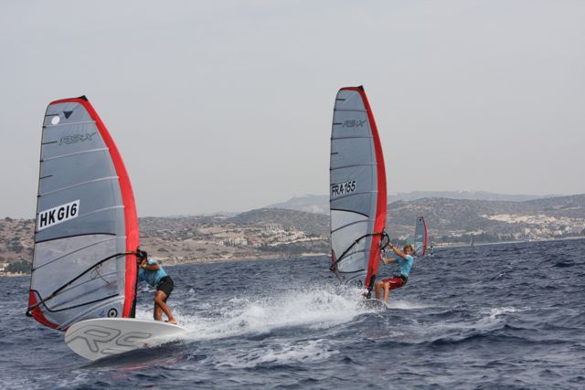 two men are wind sailing in the water