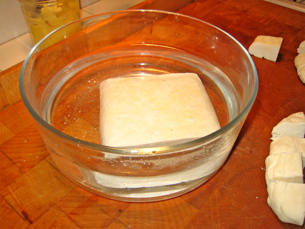 the bowl holds a square of cubed cheese