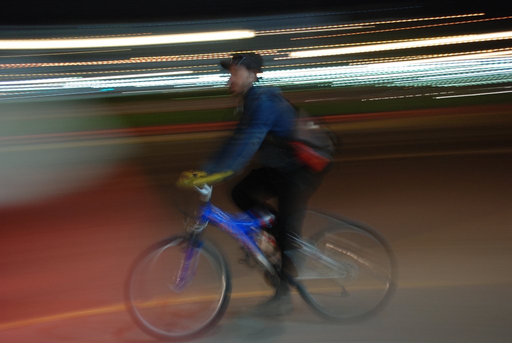 there is a person riding a bike at night