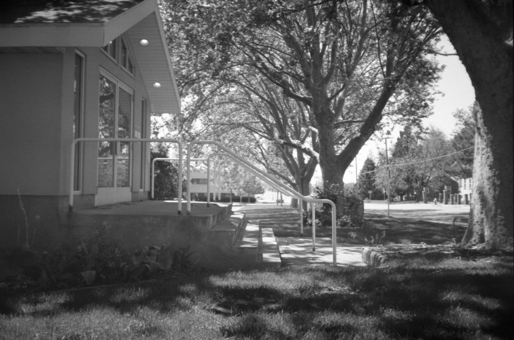 black and white po of a sidewalk in front of some houses