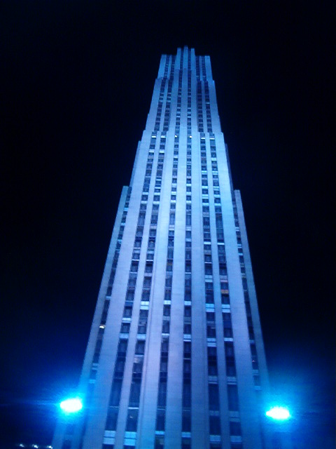 a tall skyscr lit up at night in the dark