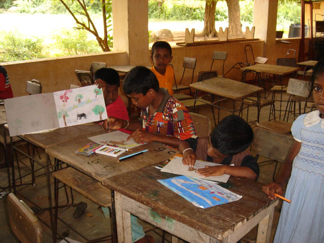 children sitting at desks in a classroom