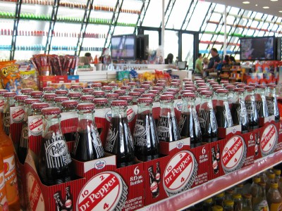 a store display with several bottles of soda