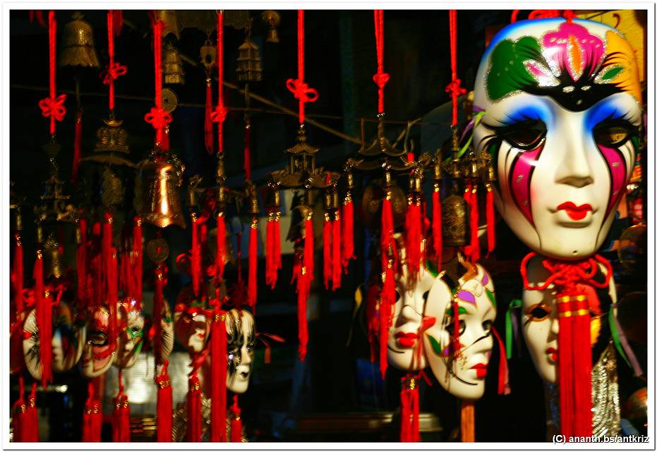 an ornate scene with several masks hanging from ropes