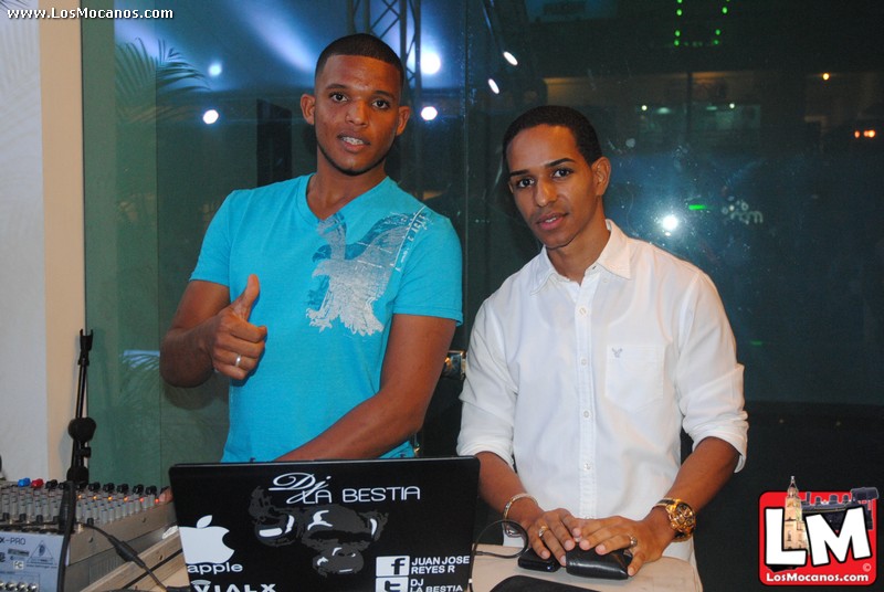 two people holding up their laptops at an event