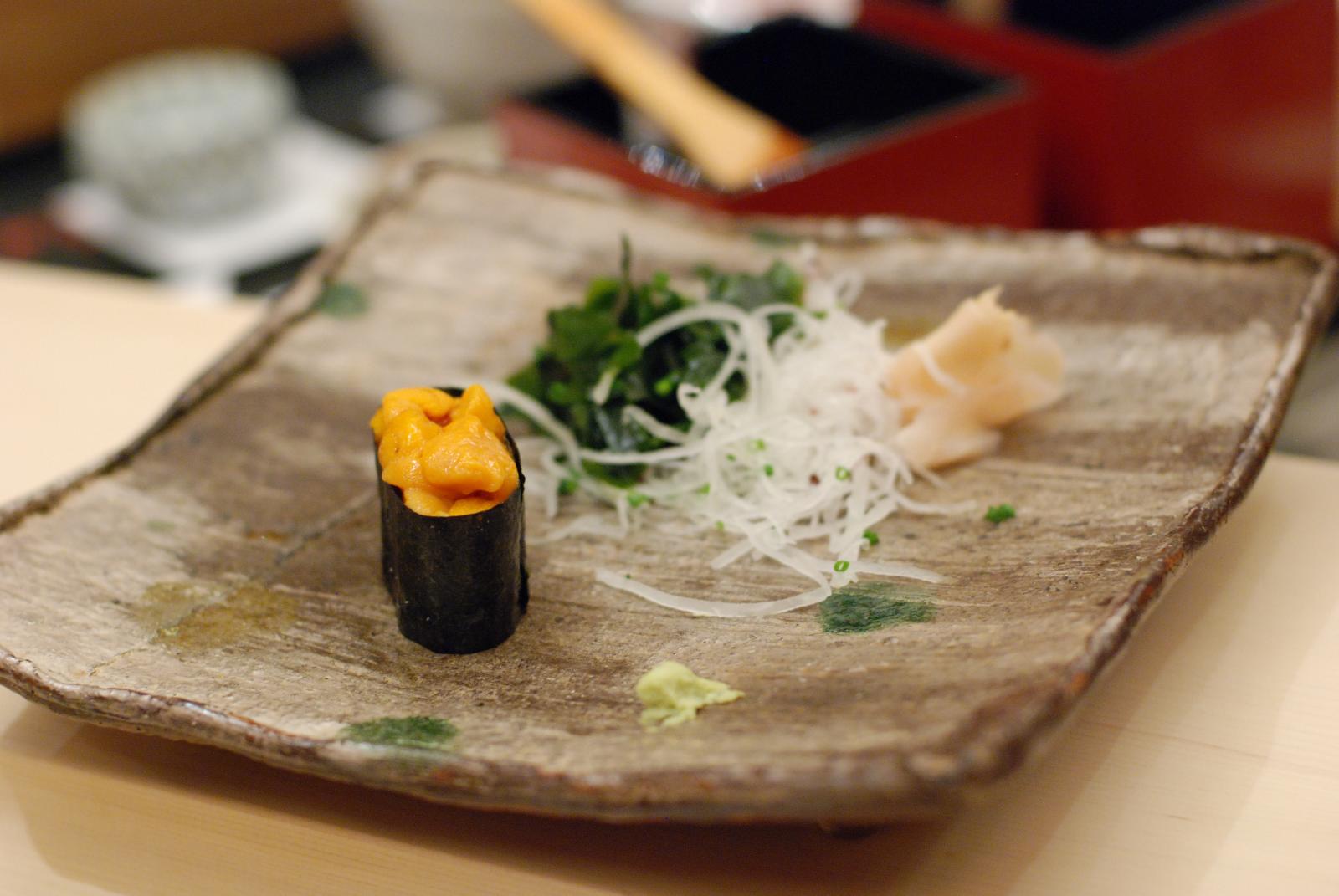 a small figurine is in a wooden plate