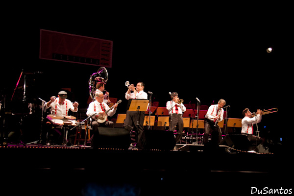 a band playing on stage with instruments and musical equipment