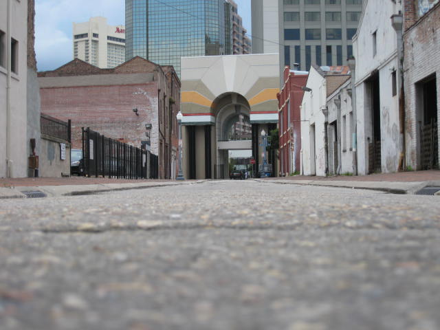 a empty alley with two tall buildings and a fire hydrant