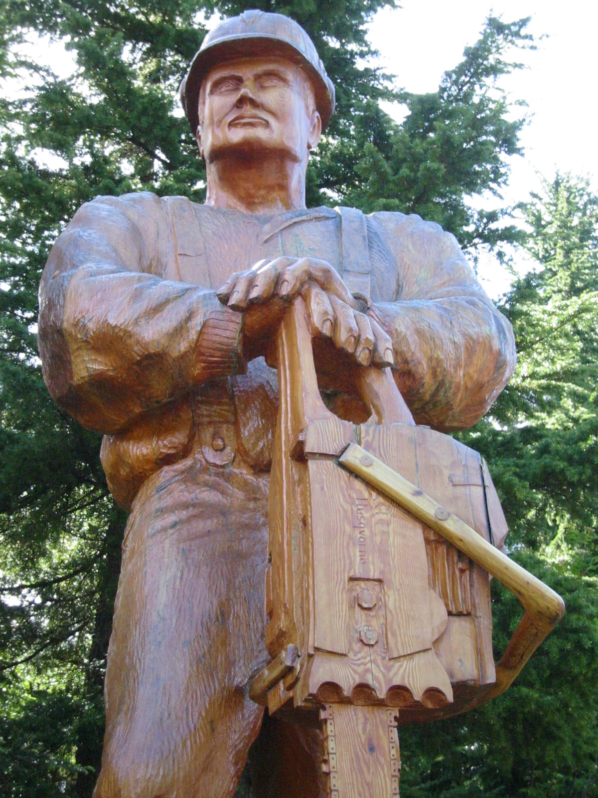 a statue of a worker with tools in his hand