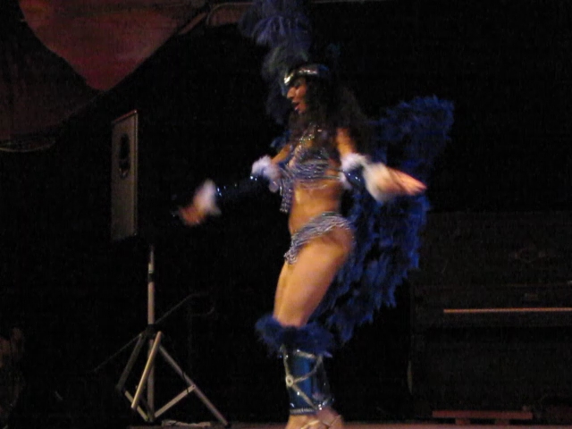 a woman is standing on a stage in  clothes