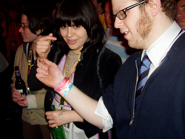 a man and woman standing together smiling at each other