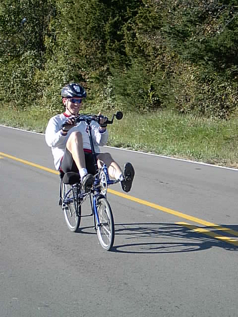 a person on a bike going down the road
