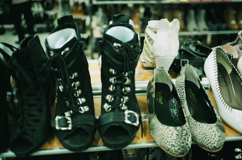 several pairs of shoes are sitting on a rack