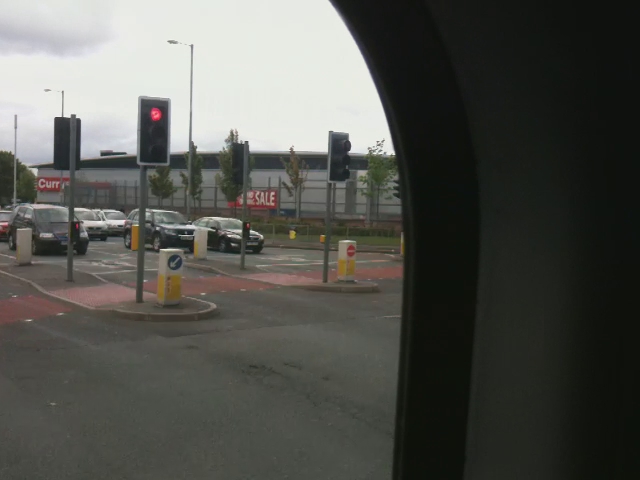 the view out the window of a passenger car looking at the traffic signal