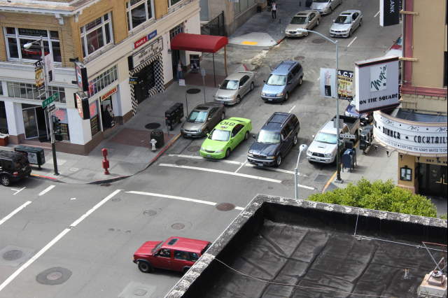 looking down at a city street full of cars