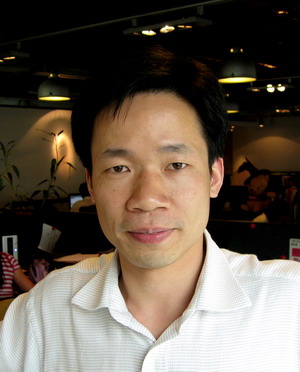 an asian man is posing for the camera