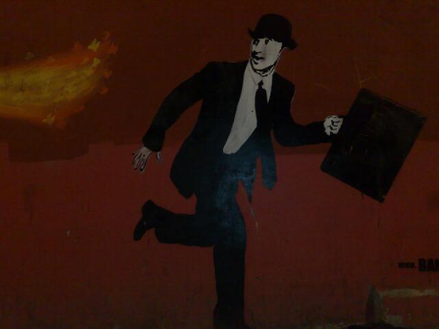 a man holding a briefcase is painted on the wall