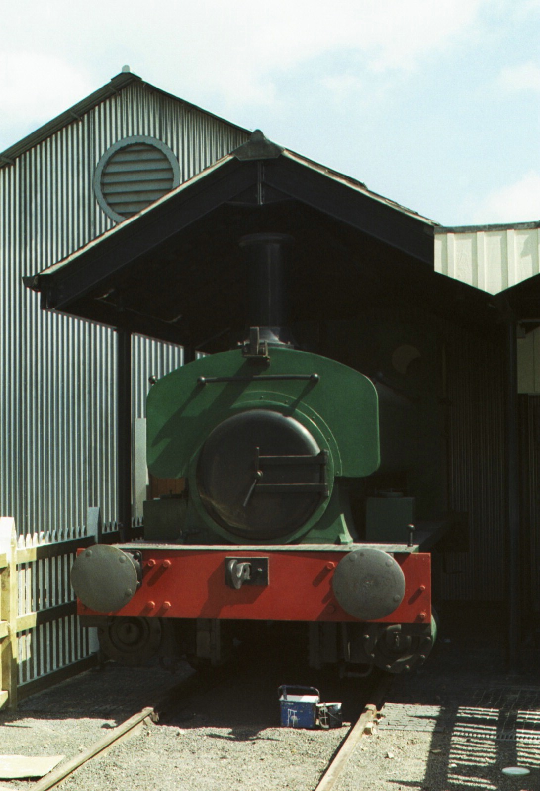 an old fashioned train engine with a covered station