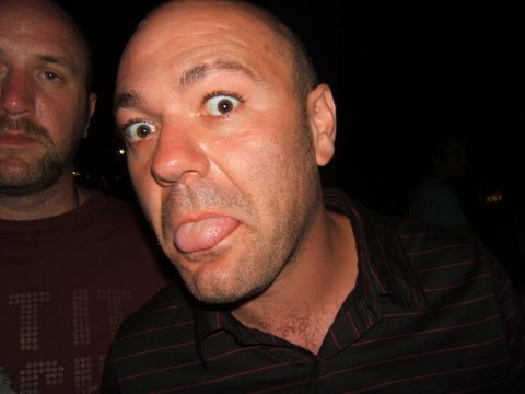 two men staring at the camera with one being surprised