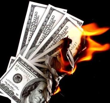 a stack of money is being lit on fire