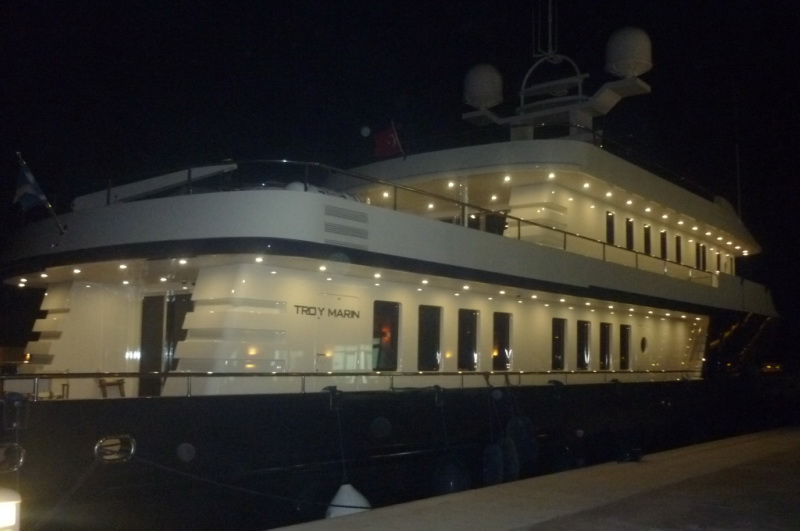 a large boat docked at night with lights