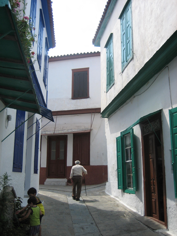 a man walking down a sidewalk near a building