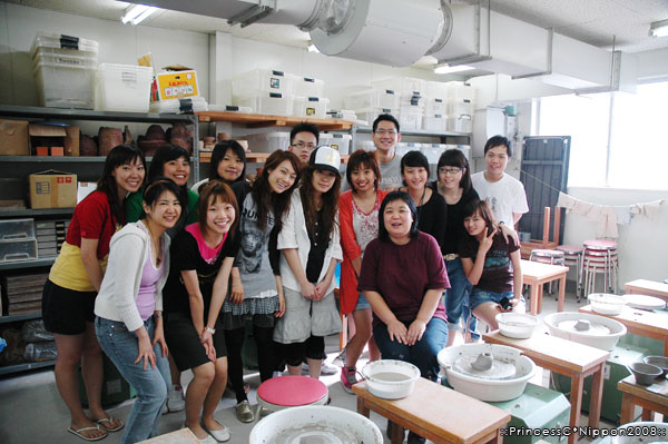 people are standing behind table with white plates