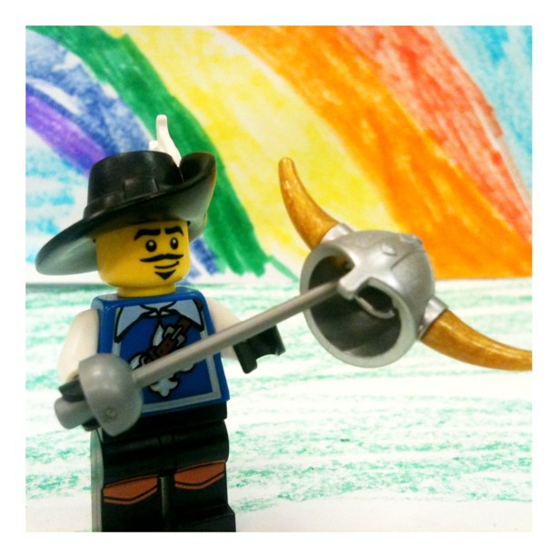 a lego figure holding a gun and a bullhorn