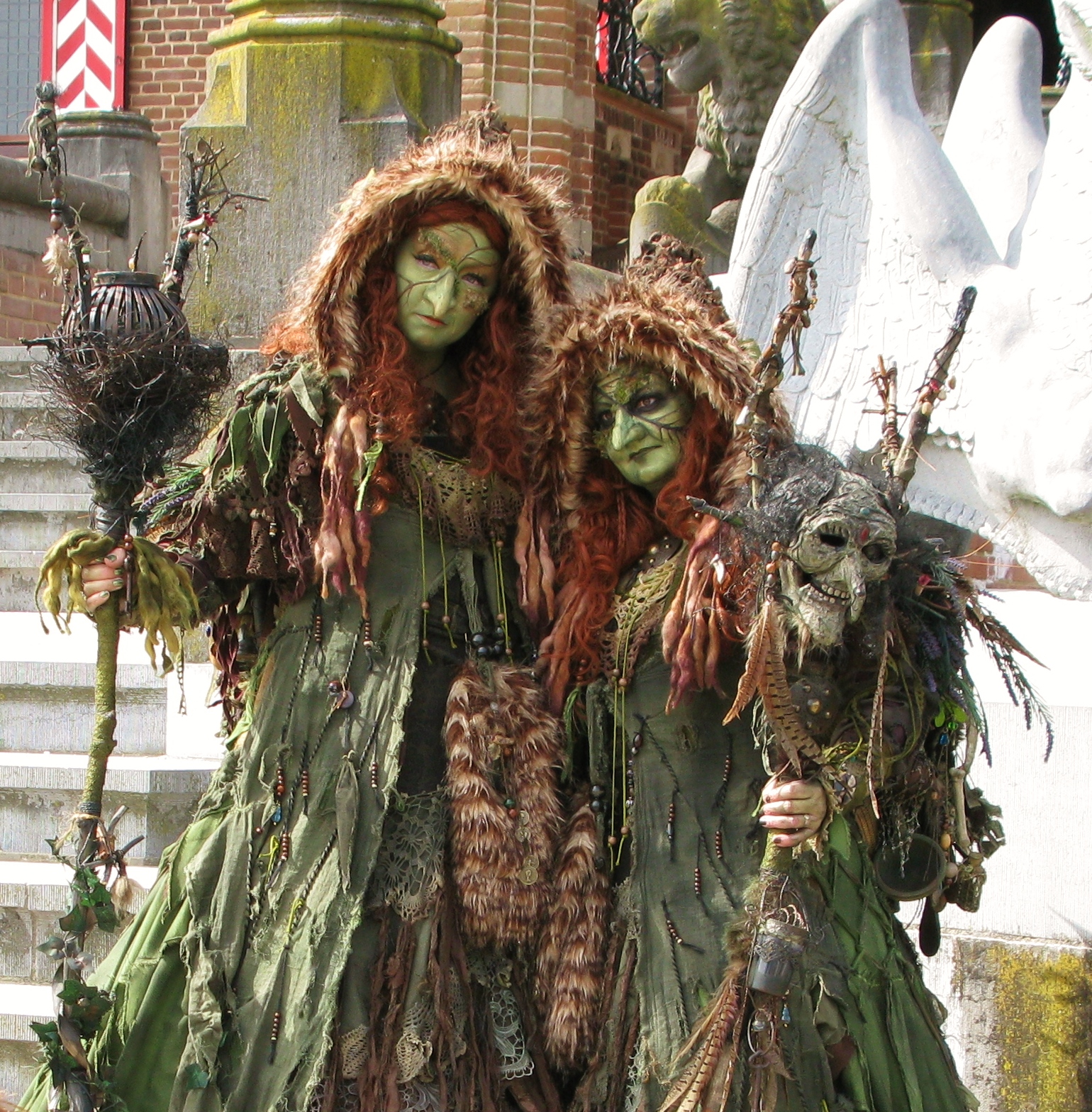 two male and female scare people dressed as plants