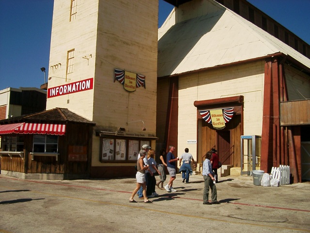 several people walk in front of an old building