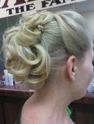 a lady with blond hair in a low bun