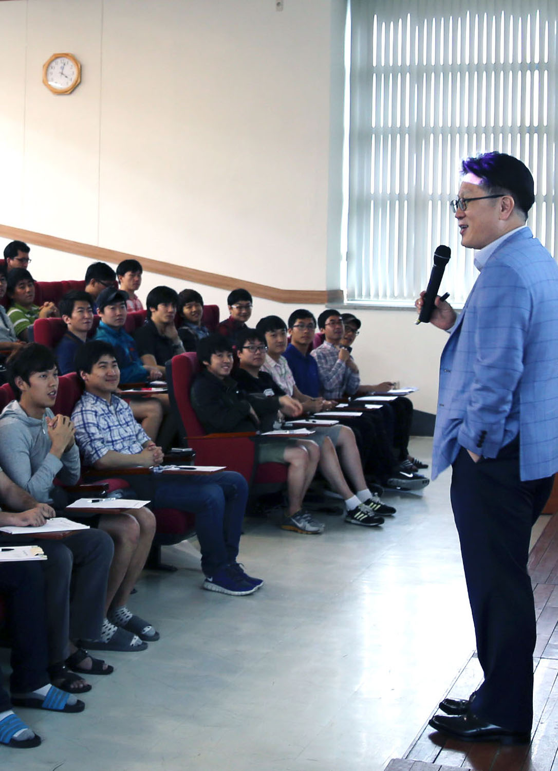 a man stands in front of a group of people