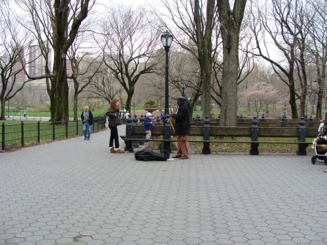 people standing on a bench in a park