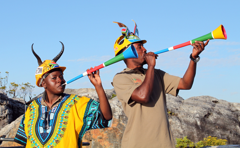 two boys holding colorful instruments to sing the devil