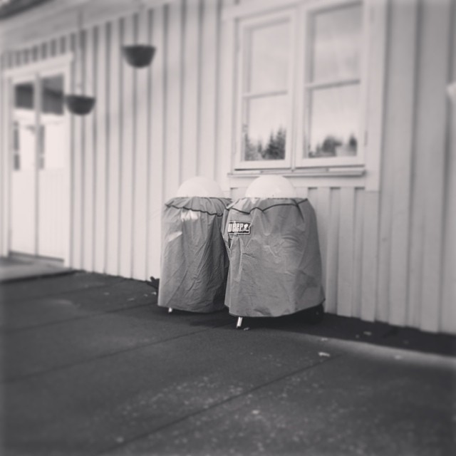 a couple of garbage cans sitting in front of a building