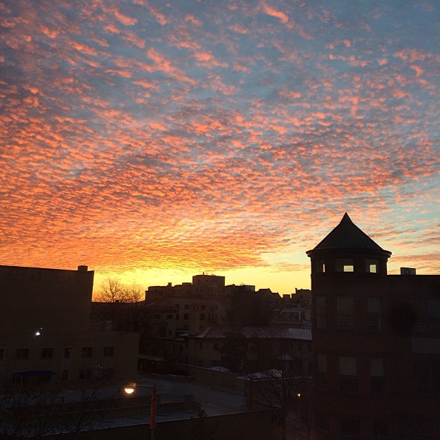 a beautiful sunset over buildings in a city