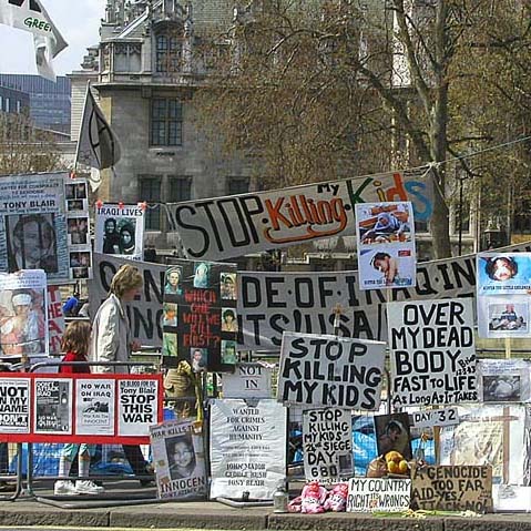 a group of signs are on the side of the road