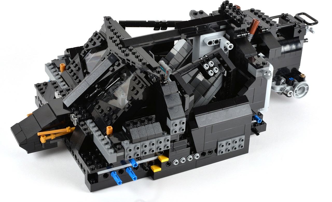 a black lego toy car with wheels and parts on it