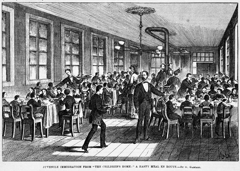 an old engraving shows people dining at a table