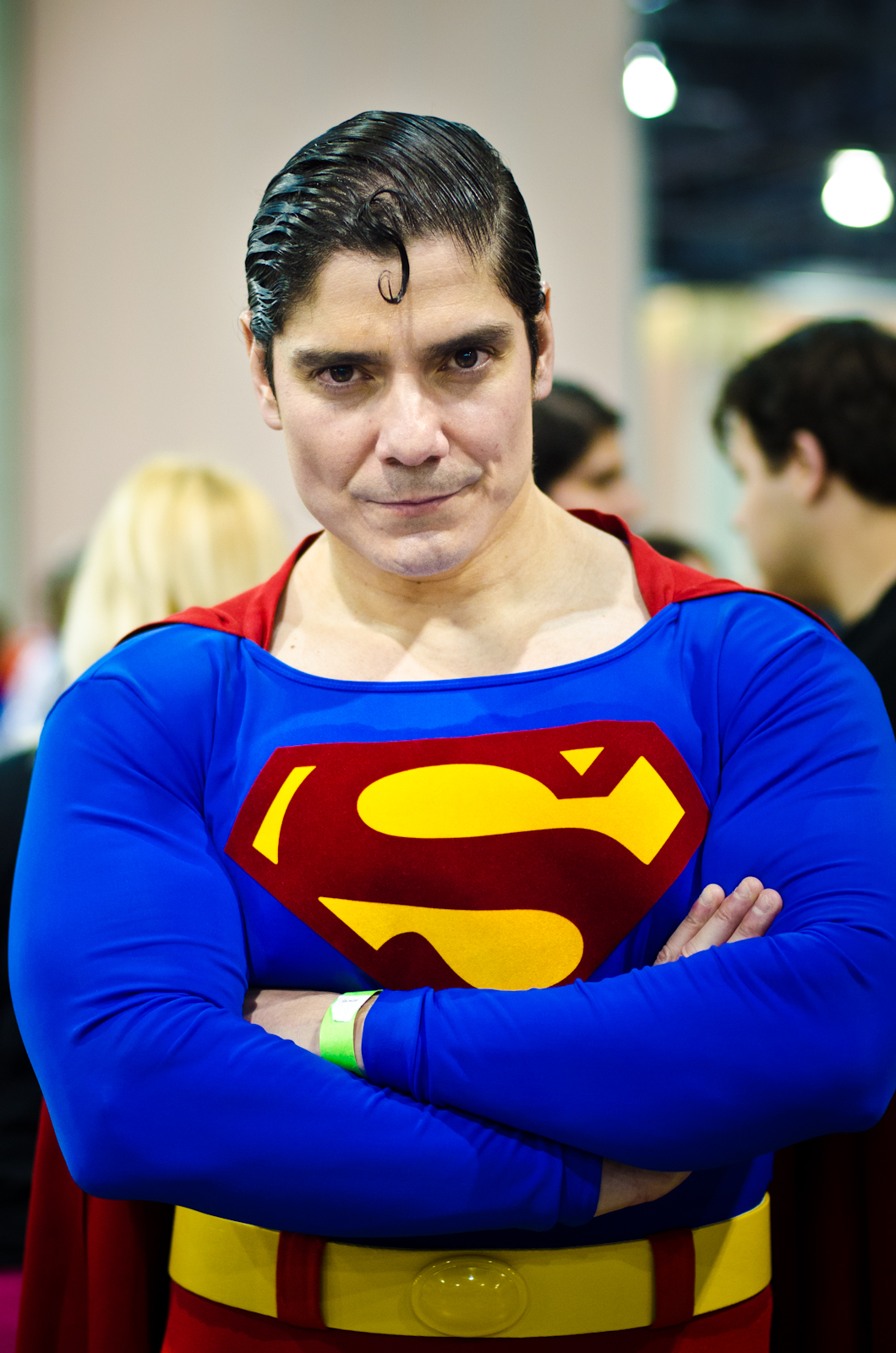 a man dressed as superman stands in a group