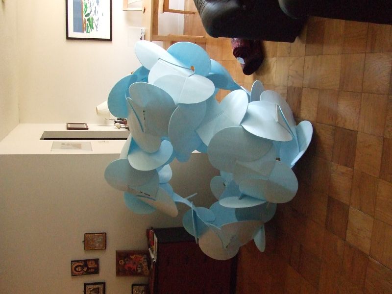 the modern sculpture is designed to look like blue paper