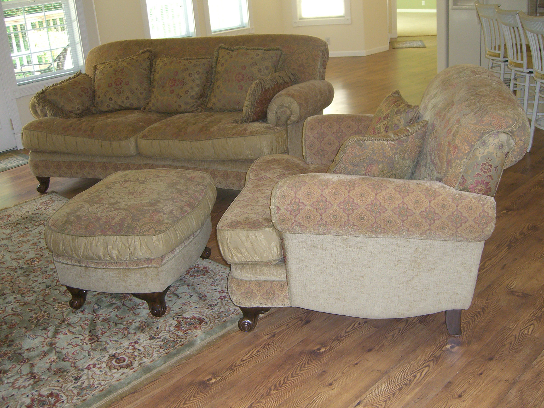 a living room with two couches and a ottoman