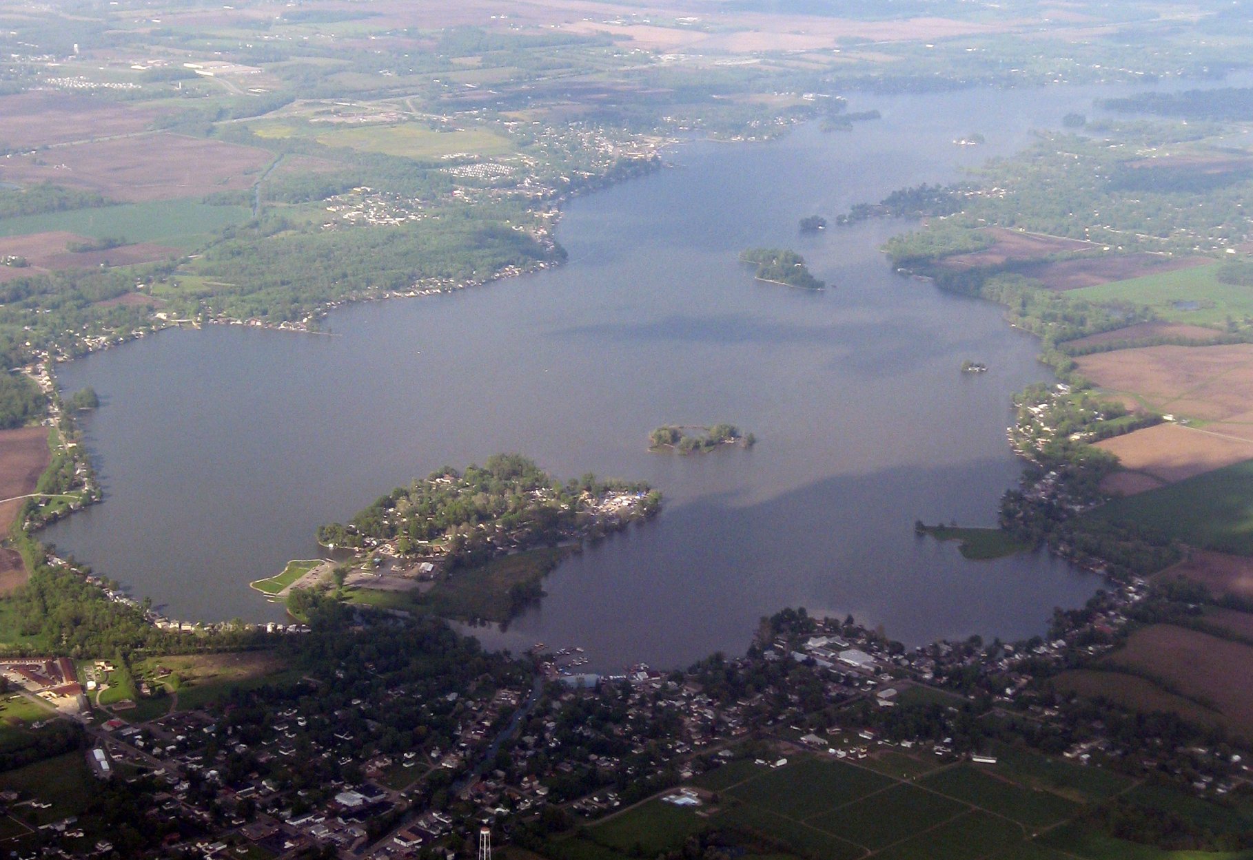 an aerial po of a lake surrounded by hills